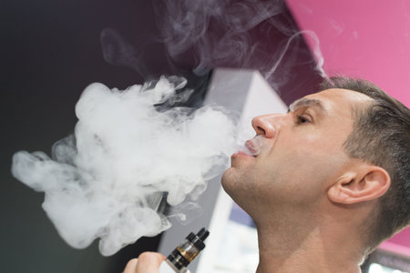 man using vapor cigarette indoor