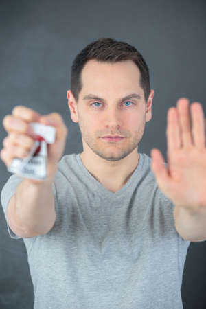 man crushing a packet of cigarettes stop smoking conceptの写真素材