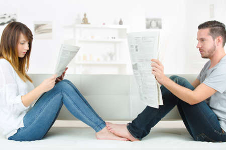 relaxing at home reading the newspaperの写真素材