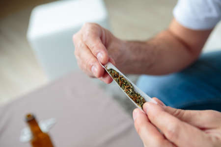 man rolling a jointの写真素材