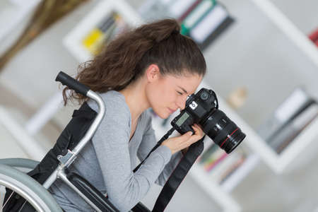 young disabled woman using a cameraの写真素材