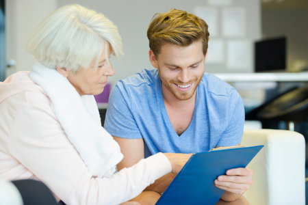 therapist showing the result to the senior patient