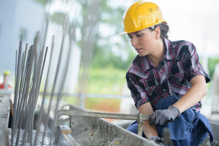 woman working on metal structureの写真素材