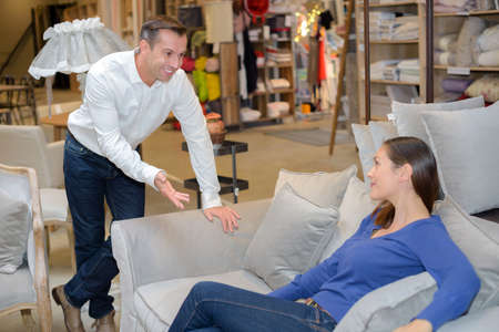 woman choosing the right furniture for her apartmentの写真素材