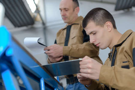 factory worker with apprenticeの写真素材