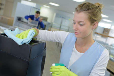 female worker cleaning ink-jet printing machineの写真素材