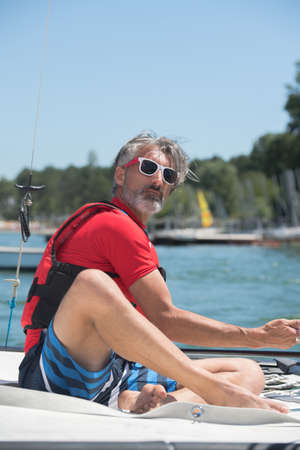 mature man sailing aloneの写真素材