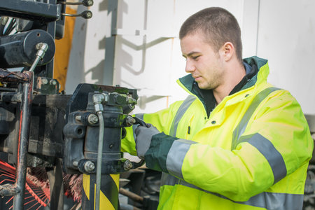 young worker machine assembling cable with terminal connector