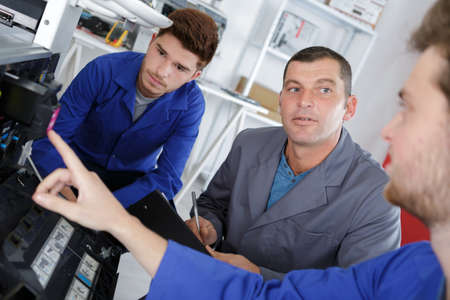 training male apprentices to use mechanized sawの写真素材