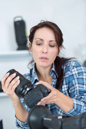 professional photographer showing how to use camera gearの写真素材