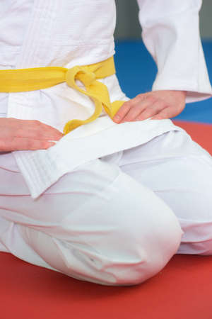 boy stands in white kimono with a yellow beltの写真素材