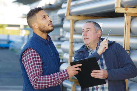 worker giving the record to the colleagueの写真素材