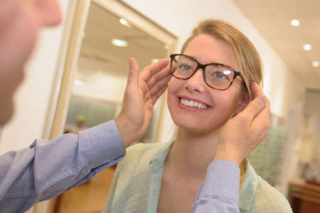 fitting the new pair of eyeglassesの写真素材