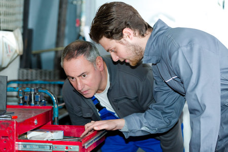 engineer and apprentice planning cnc machinery project