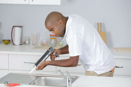 plumber in kitchenの写真素材