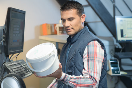 supervisor with clipboard checking barcode at the warehouse