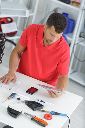 man checking on tablet how to fix something