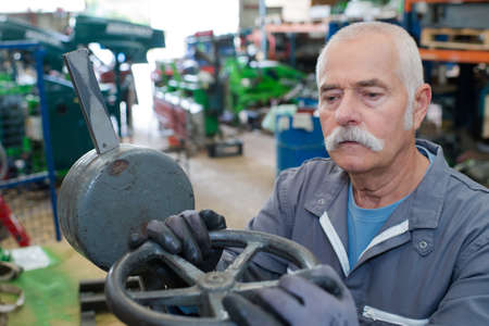 senior mechanic works at a factoryの写真素材