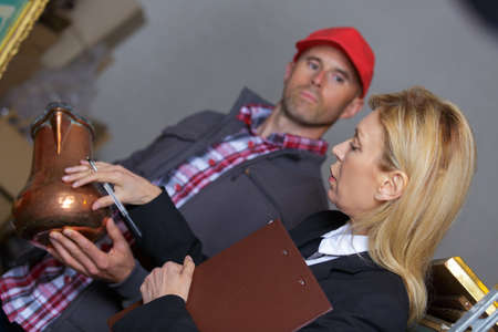 buying a cooper vase in an old antique shopの写真素材