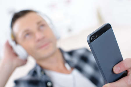 handsome man listens to music in his ipodの写真素材