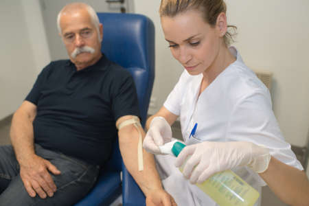 preparation for blood test with beautiful young blond doctorの写真素材