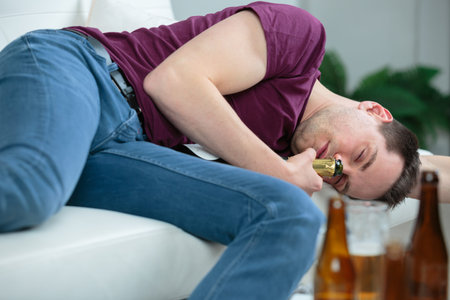 drunken man resting at home with a beer