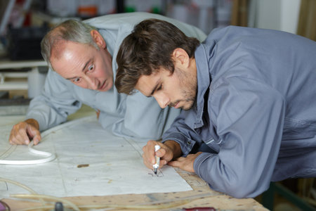 apprentice engineer measuring component with micrometer