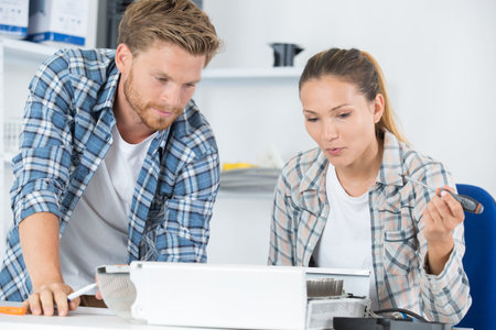 couple fixing computer together