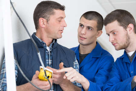 apprentices learning to use machineの写真素材