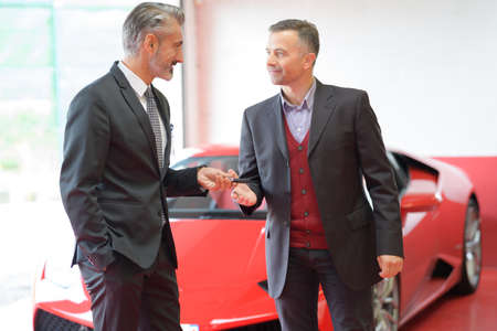 attractive man buying a carの写真素材