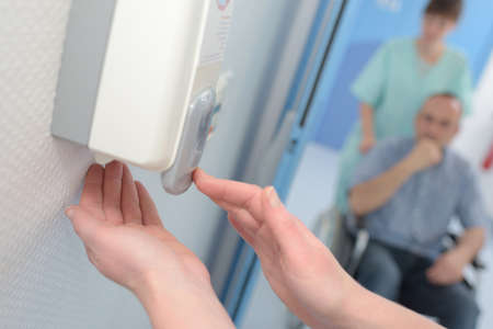 automatic liquid soap dispenser on wall for hand cleaningの写真素材