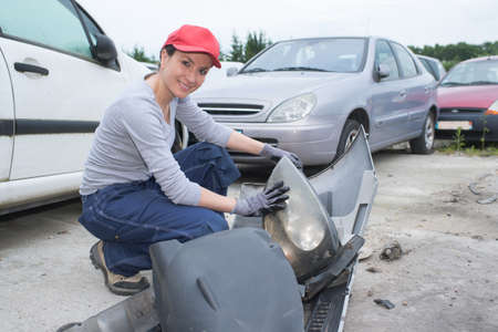 woman working at a car junkyardの写真素材