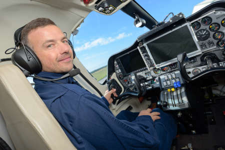handsome male pilot in the cockpitの写真素材