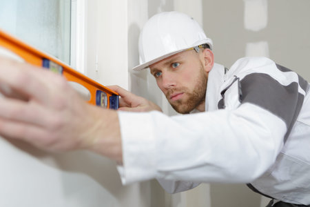 young man viewing a spirit level