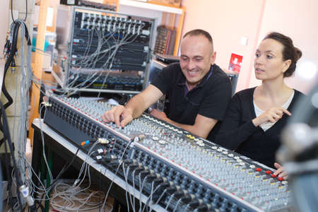 artists producing music in their home sound studioの写真素材