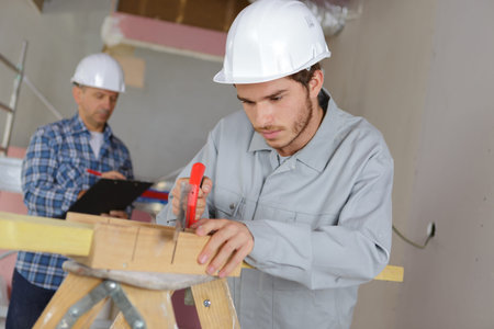 carpenter with apprentice in training period