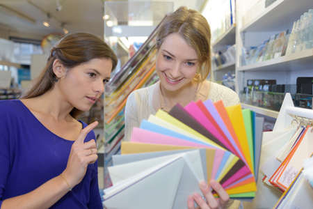 two women and colorful paperの写真素材