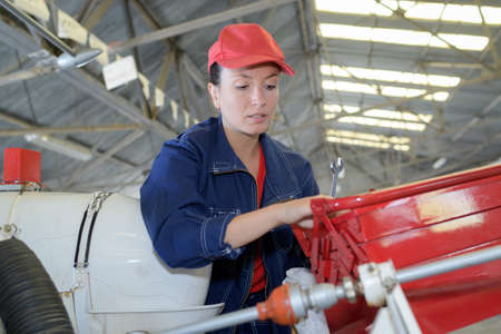 female helicopter mechanic working hardの写真素材