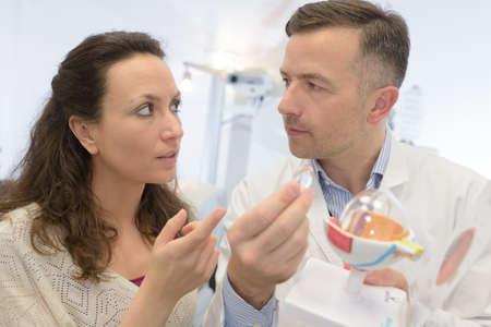 smiling young couples in kitchenware section in supermarketの写真素材