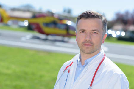 portrait of a male doctor near emergency helicopterの写真素材