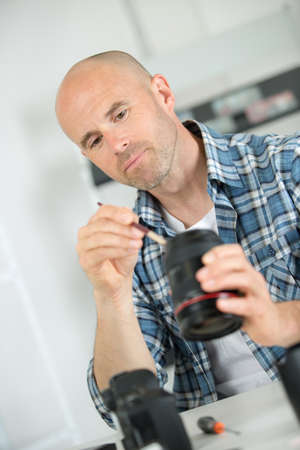 Technician working on camera lensの写真素材
