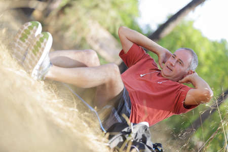 Middle aged man doing sit upsの写真素材