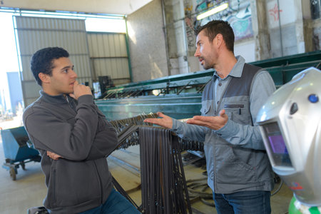 Two men talking in industrial factory