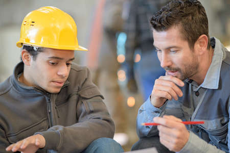 factory workers discussing planningの写真素材