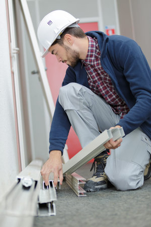 Workman holding pvc frames