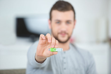man hand holding flash drive