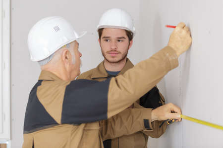 builders drawing the line on the wallの写真素材