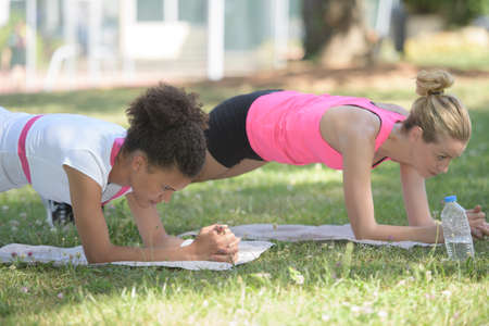 fit young women doing plank position outdoorssの写真素材