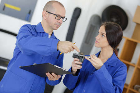 girl student mechanic studying part of the deviceの写真素材