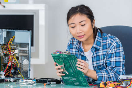 female technician working with transistorの写真素材